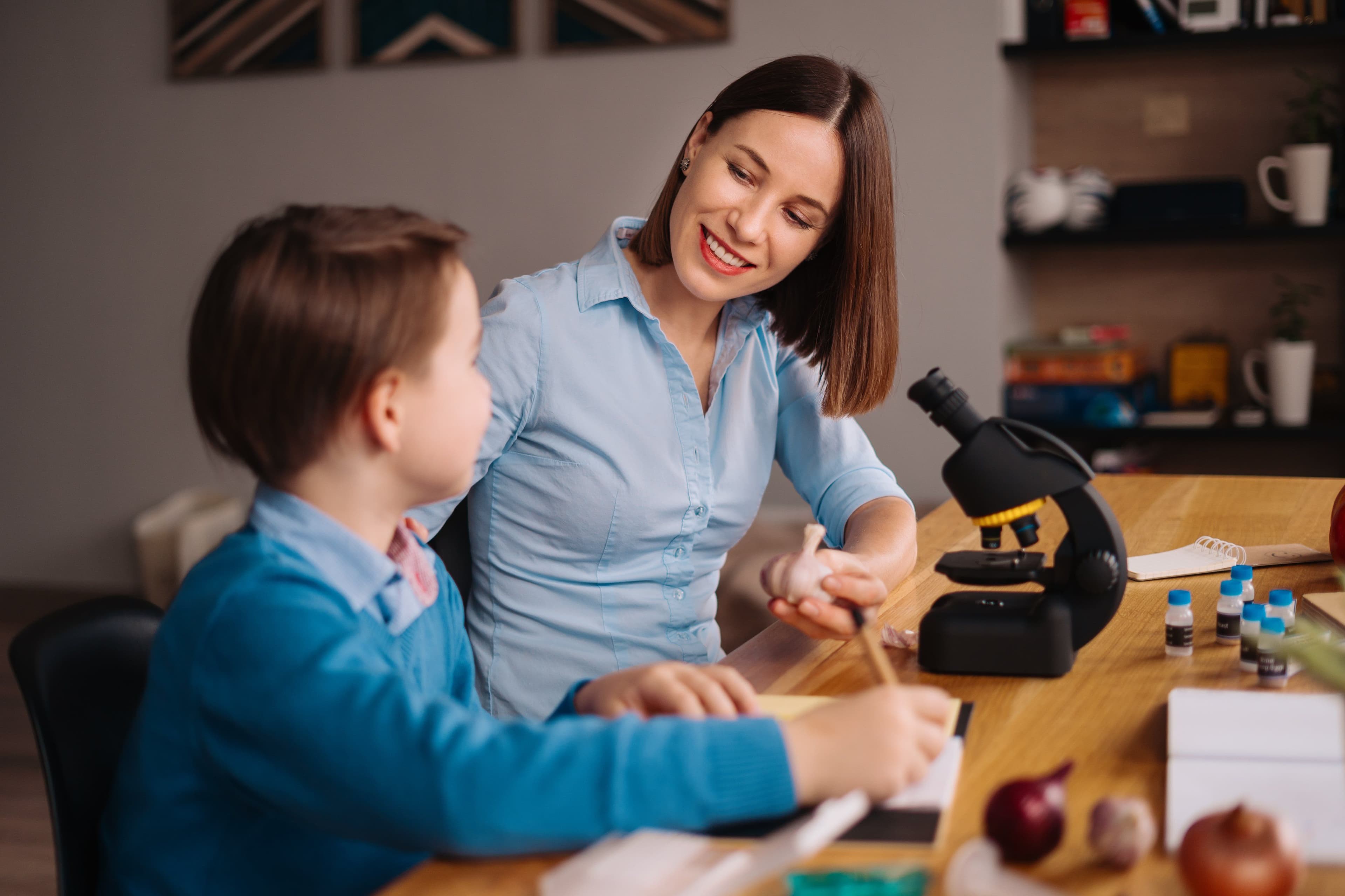 Home learning, woman and boy study at the table