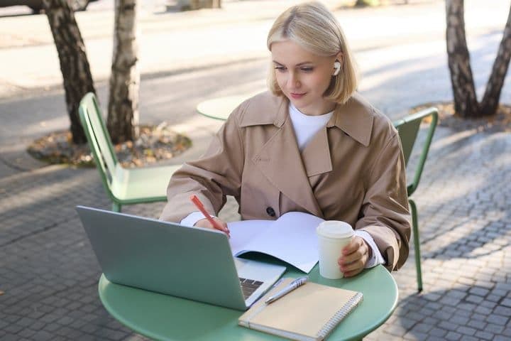 portrait-beautiful-blond-woman-wearing-wireless-headphones-using-laptop-studying-outdoor_720